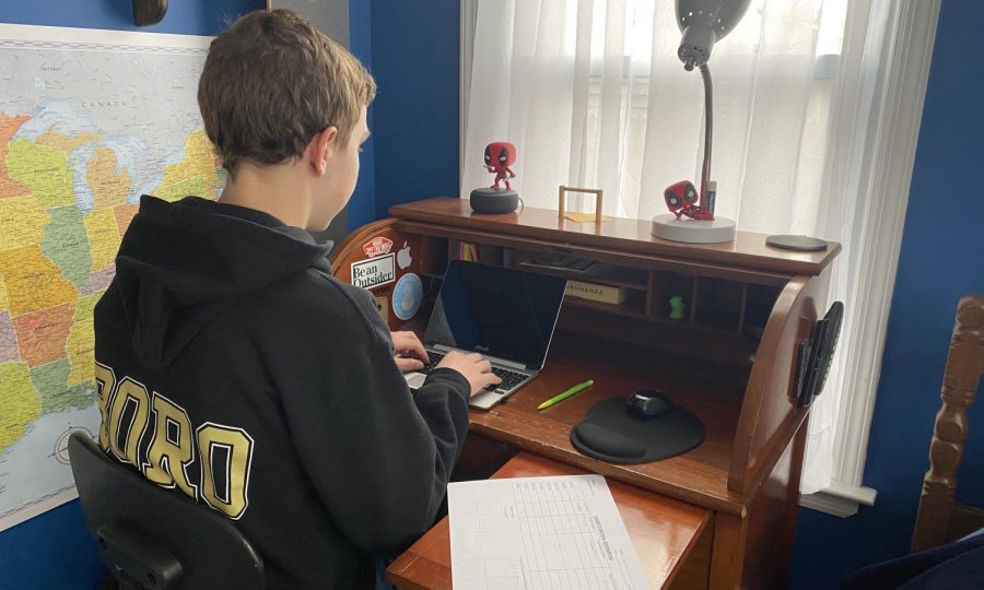 Sophomore, Evan Melito, does his online school work from his room.