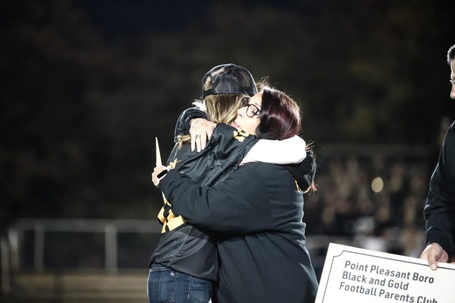 Gina Mazzaro and mother of Van-Trease family hug after gifting her the surprise donation.
