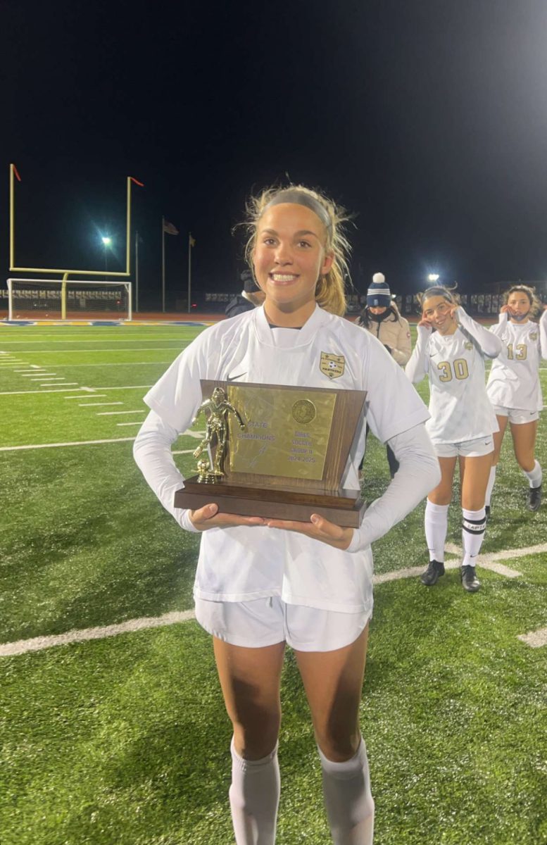 Junior, Lily Scalabrini holding the trophy.